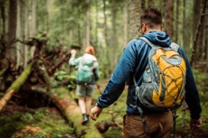 A couple hiking the trails in Yosemite. Be sure you have a good backpack to carry your essentials.