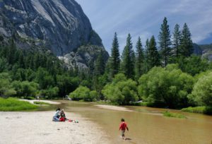 Family hiking near the Merced River in Yosemite.